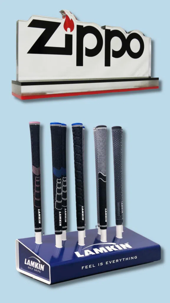 Zippo Brand Signage and Lamkin Grip Display | BAW Plastics Inc. | BAW Plastics Inc. Lamkin golf grips displayed on a blue stand beneath a large Zippo sign against a light blue background, showcasing six grip designs.