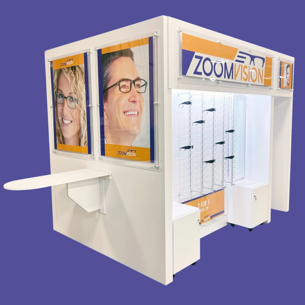 Wooden Eyeglass Kiosk Display | BAW Plastics Inc. | BAW Plastics Inc. White exhibition kiosk for ZoomVision eyewear with poster panels and a wall of sunglasses on racks, set against a purple background.